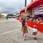 Rodeo Houston Kids Walking by Game Booths in Carnival